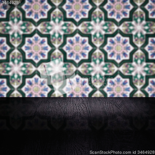 Image of Wood table top and blur vintage ceramic tile pattern wall