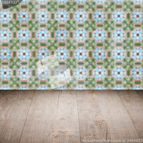 Image of Wood table top and blur vintage ceramic tile pattern wall