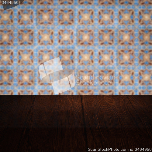 Image of Wood table top and blur vintage ceramic tile pattern wall