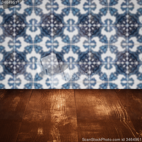 Image of Wood table top and blur vintage ceramic tile pattern wall