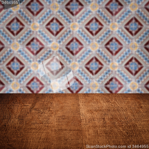 Image of Wood table top and blur vintage ceramic tile pattern wall