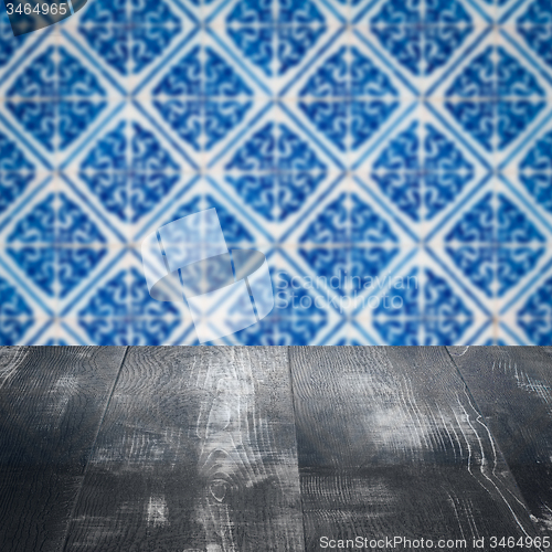 Image of Wood table top and blur vintage ceramic tile pattern wall