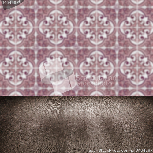 Image of Wood table top and blur vintage ceramic tile pattern wall