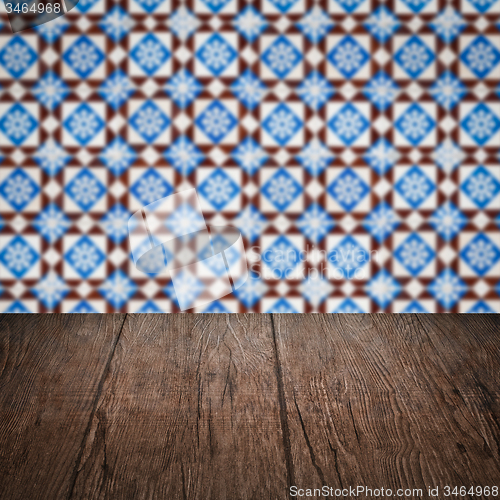 Image of Wood table top and blur vintage ceramic tile pattern wall