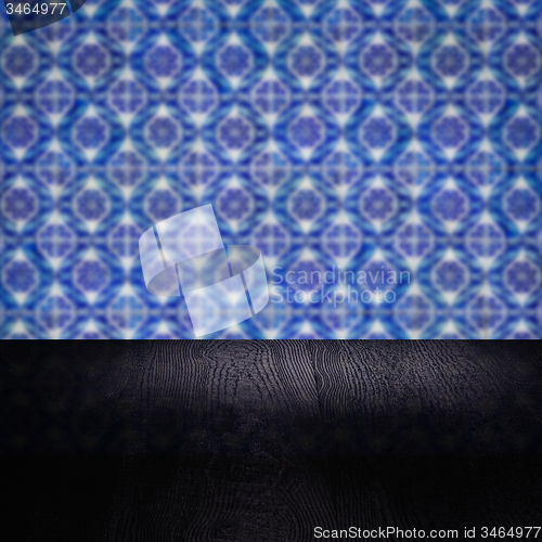 Image of Wood table top and blur vintage ceramic tile pattern wall