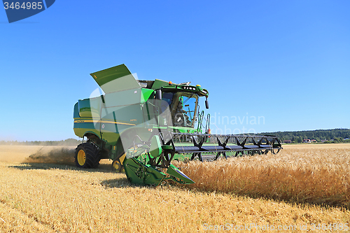 Image of John Deere Combine s670i Harvests Barley on a Sunny Day