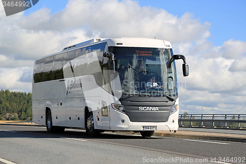 Image of White Scania Touring Bus on the Road at Summer