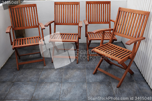 Image of four folding wooden chairs 