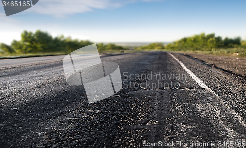 Image of bad asphalt road