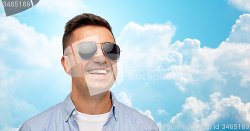 Image of face of smiling man in shirt and sunglasses