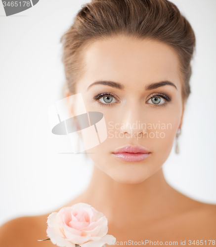 Image of young woman with rose flower