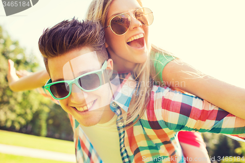 Image of smiling couple having fun in park