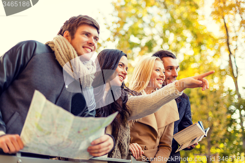 Image of group of friends with map outdoors