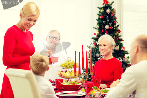 Image of smiling family having holiday dinner at home