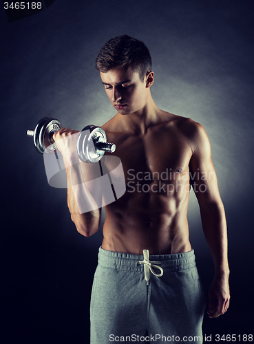 Image of young man with dumbbell