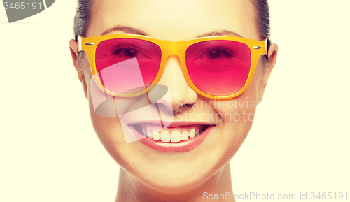 Image of smiling teenage girl in pink sunglasses