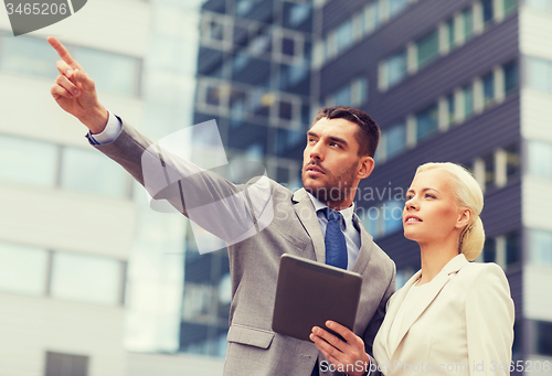 Image of serious businessmen with tablet pc outdoors