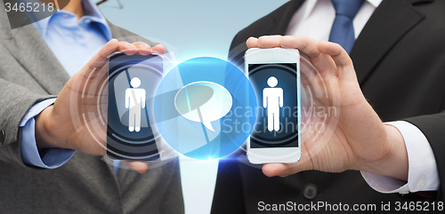 Image of businessman and businesswoman with smartphones