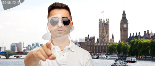 Image of man in sunglasses pointing finger on you