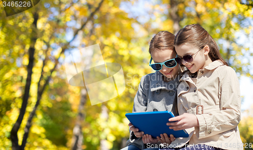 Image of happy girls with tablet pc computer outdoors