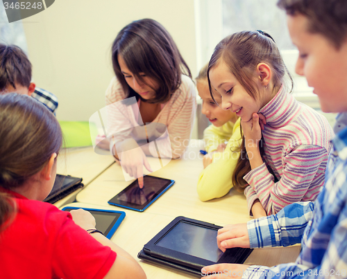 Image of group of school kids with tablet pc in classroom