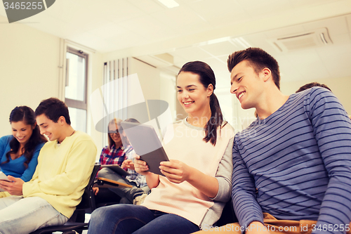 Image of group of smiling students with tablet pc