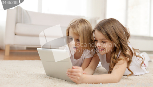 Image of two little girls with tablet pc at home