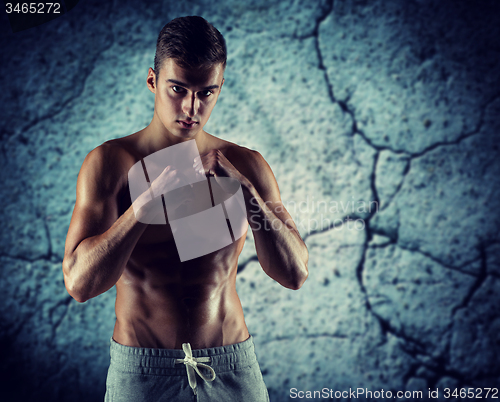 Image of young man in fighting or boxing position