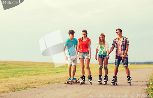 Image of group of smiling teenagers with roller-skates