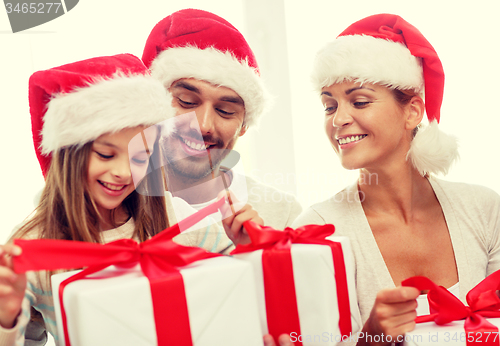 Image of happy family sitting on couch at home