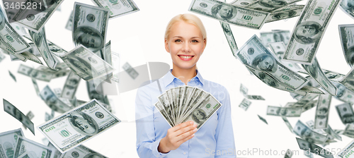 Image of smiling businesswoman with dollar cash money