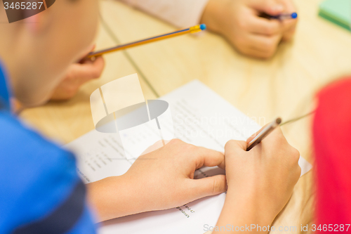 Image of close up of schoolboy writing test at school