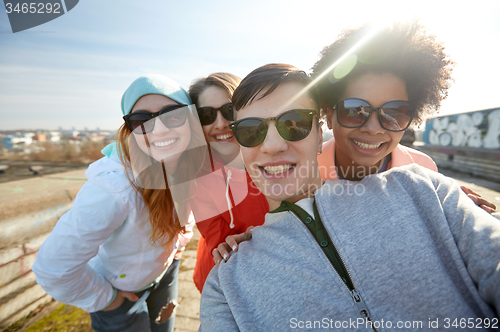 Image of group of happy friends taking selfie on street
