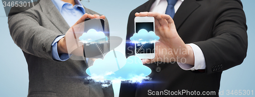 Image of businessman and businesswoman with smartphones