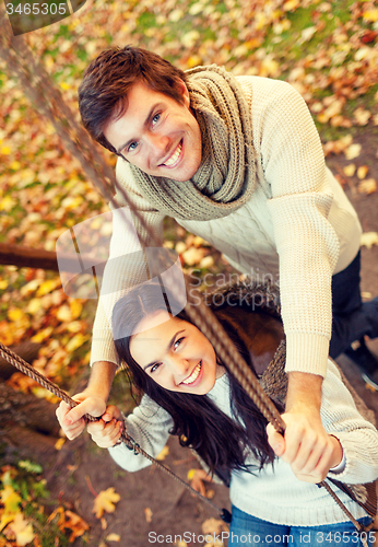 Image of smiling couple hugging in autumn park