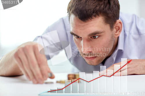 Image of businessman with coins at office