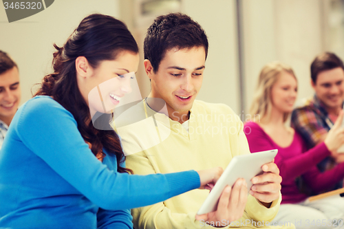 Image of group of smiling students with tablet pc