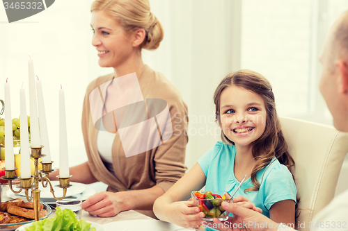 Image of smiling family having holiday dinner at home
