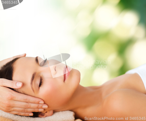 Image of beautiful woman in spa salon having facial