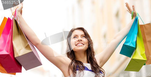 Image of beautiful woman with shopping bags in the ctiy