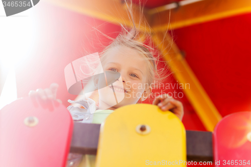 Image of happy little girl on children playground