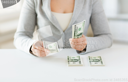 Image of close up of woman hands counting us dollar money