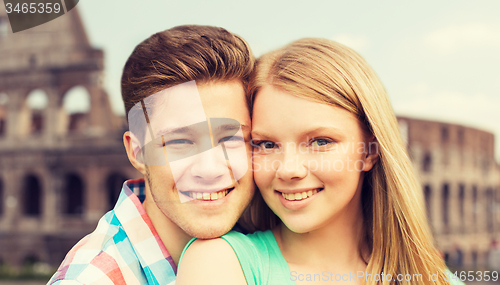 Image of smiling couple over coliseum background