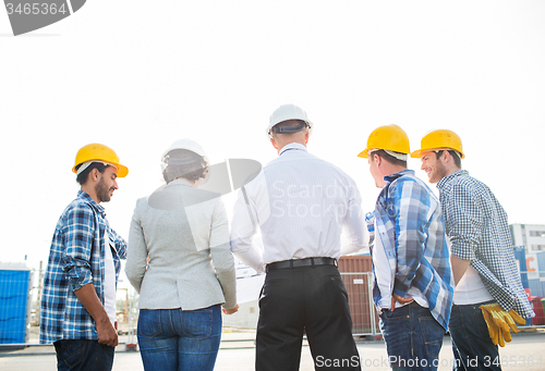 Image of group of builders and architects at building site