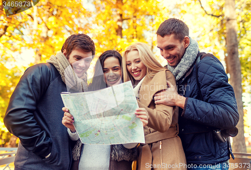 Image of group of friends with map outdoors