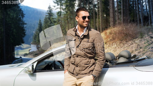 Image of happy man near cabriolet car over nature