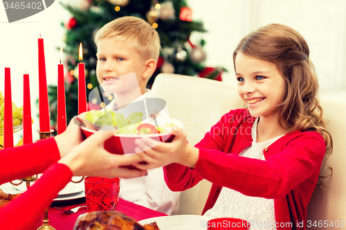 Image of smiling family having holiday dinner at home