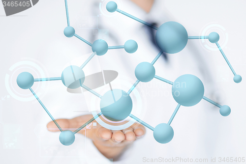 Image of close up of male doctor hand with molecules