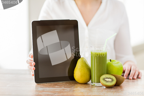 Image of close up of woman hands tablet pc and fruit juice