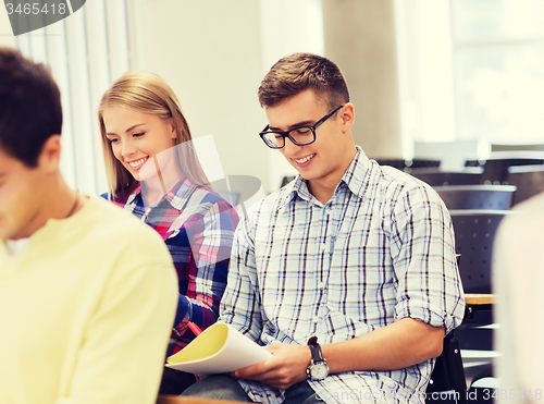 Image of group of smiling students with notebook
